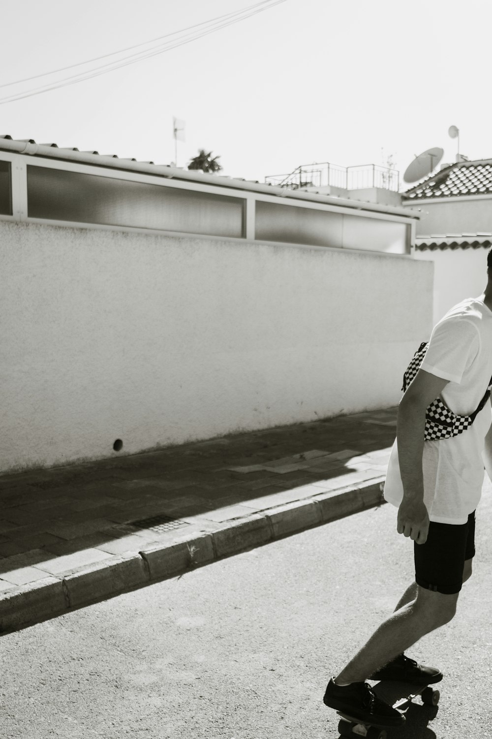 grayscale photography of man standing near pavement