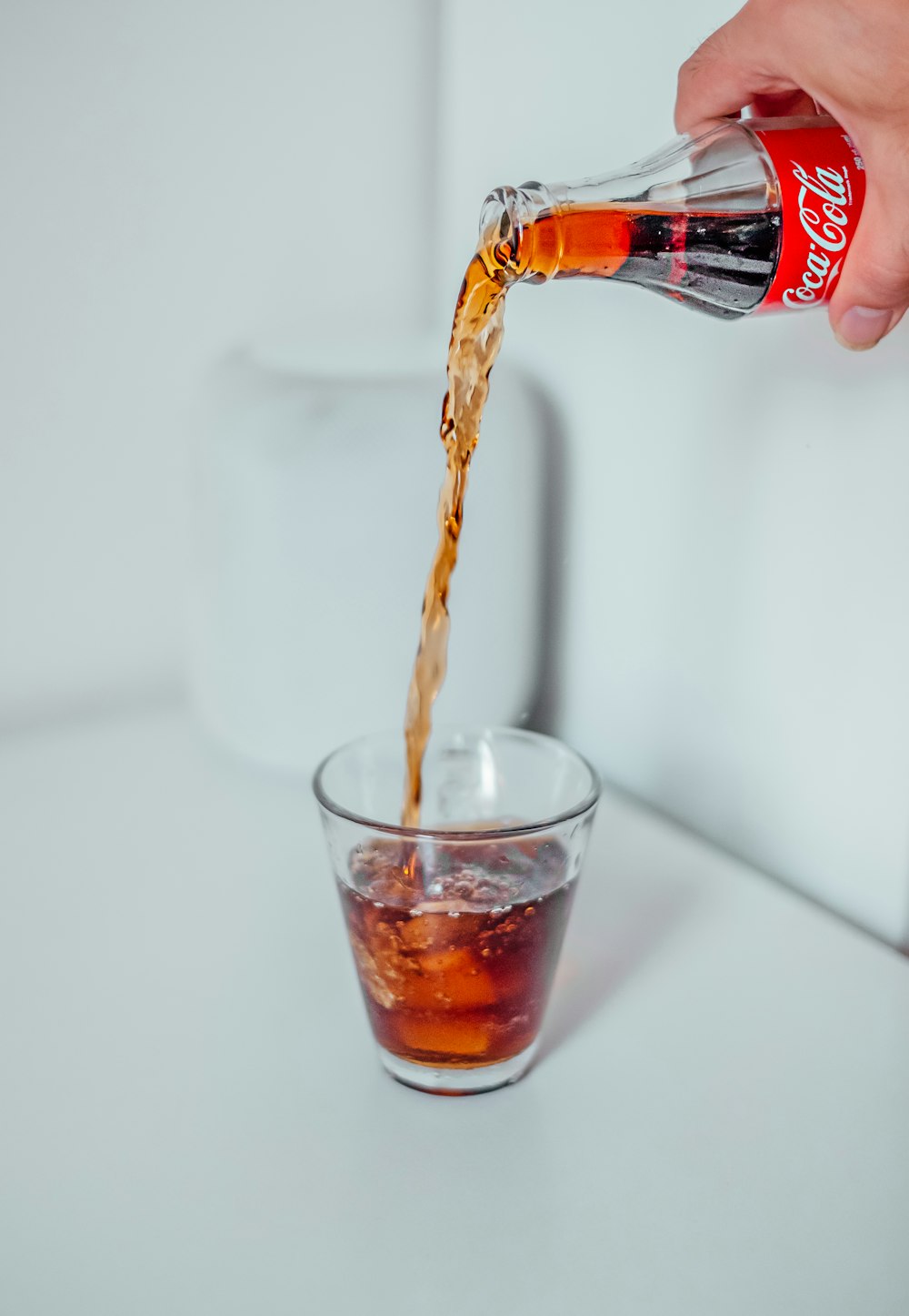 person holding Coca-Cola bottle