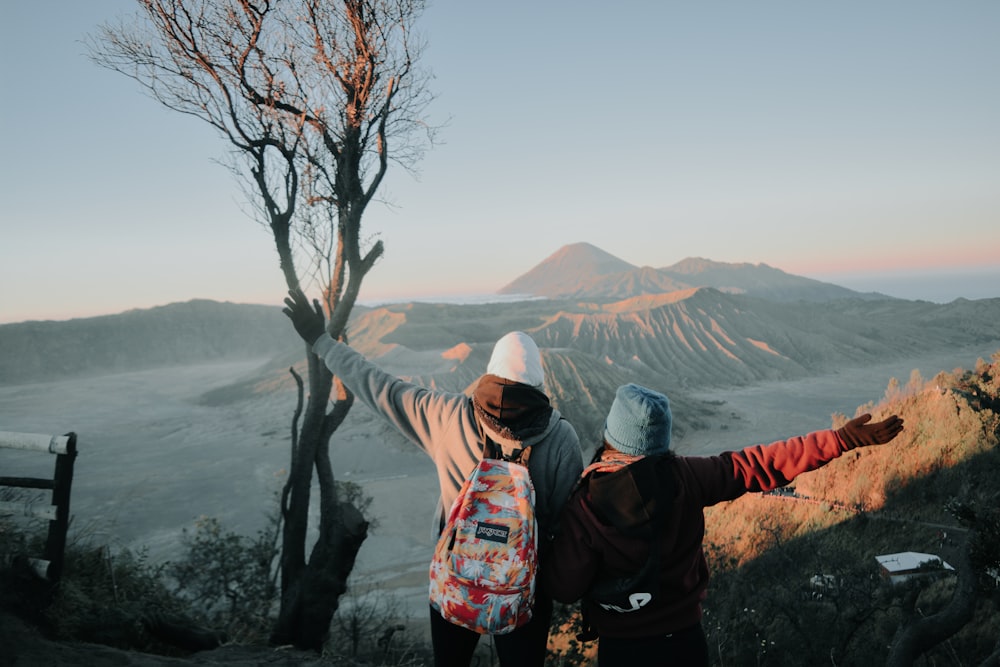 two person looking at mountains