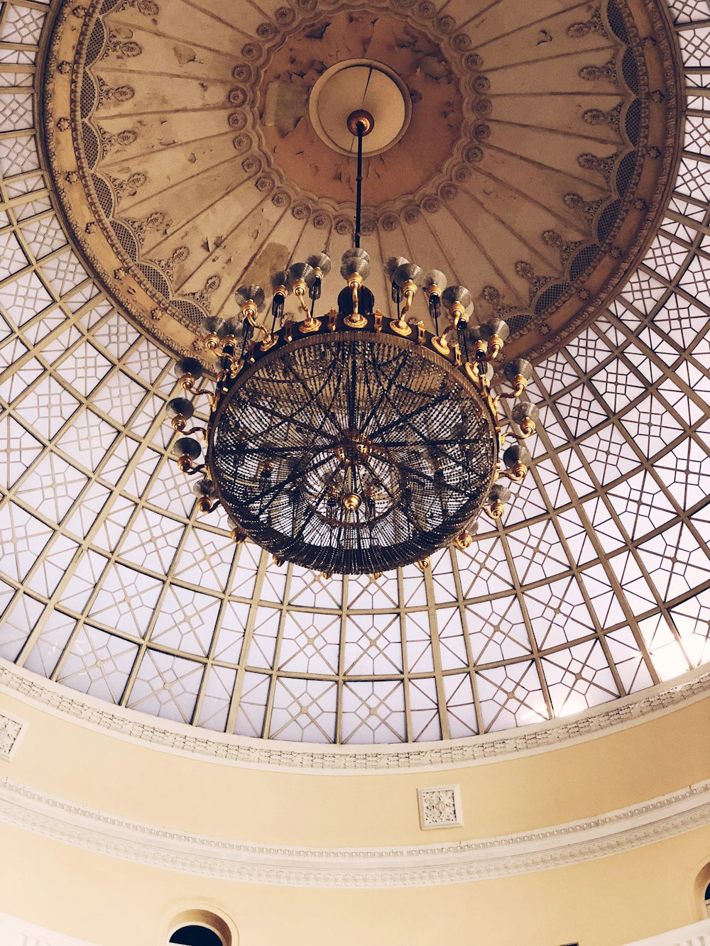 brass-colored uplight chandelier