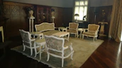 Artful arrangement of living room furniture blending classic wood craftsmanship with contemporary design.