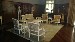 Artful arrangement of living room furniture blending classic wood craftsmanship with contemporary design.