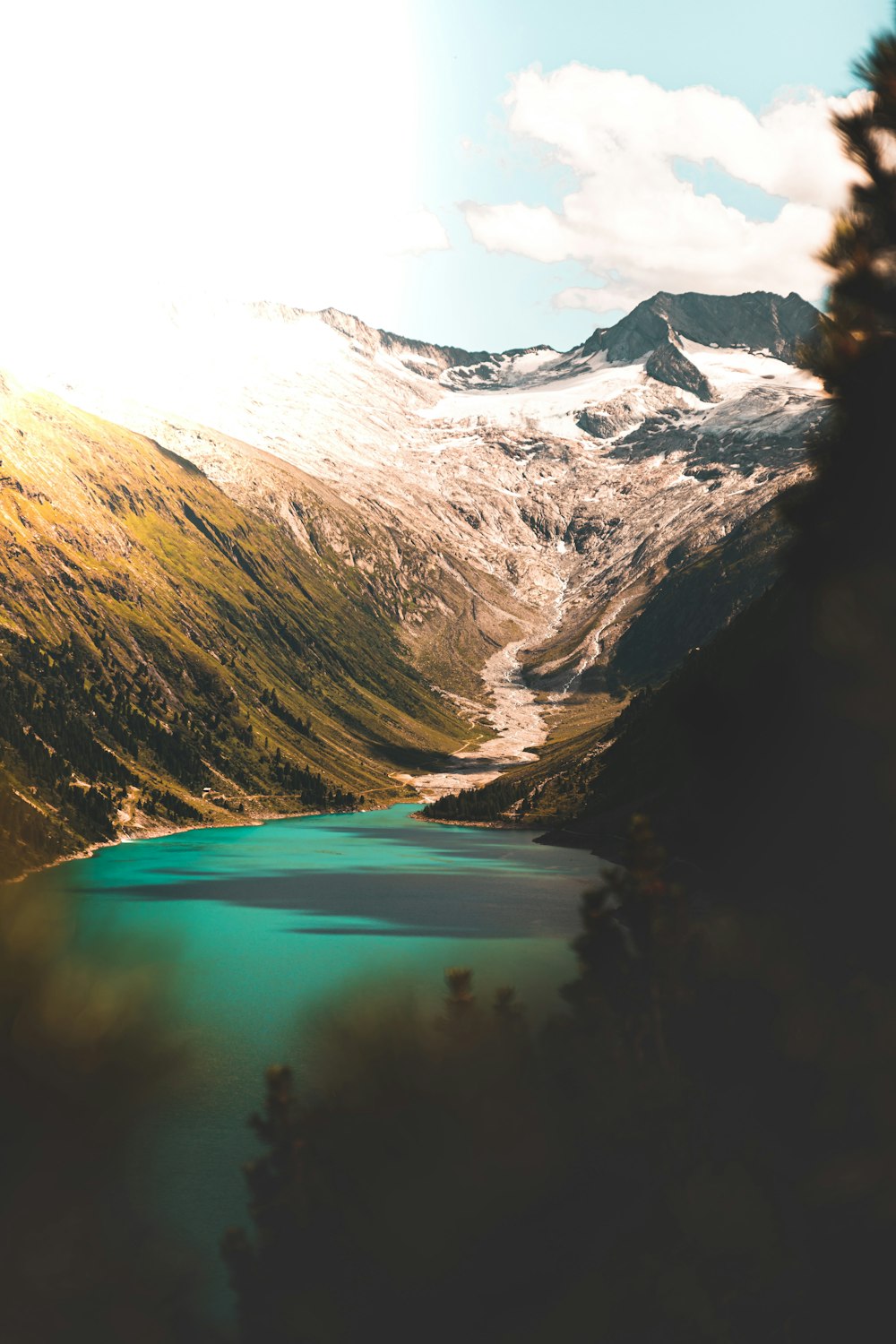 photography of lake between mountain during daytime