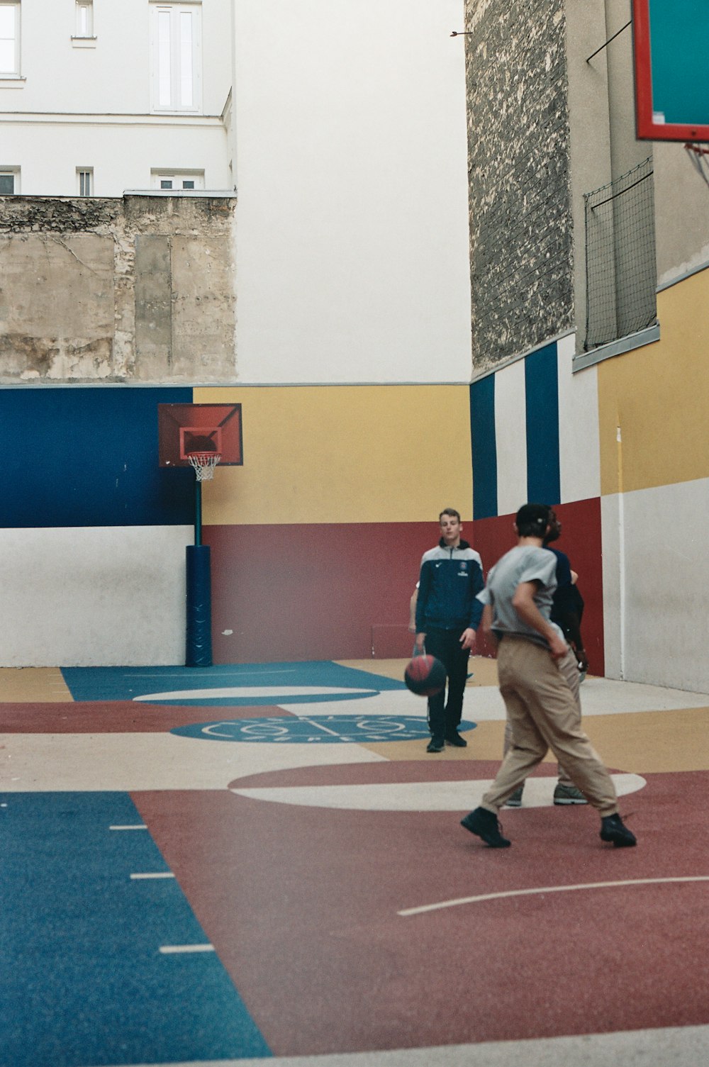 three men playing basketball