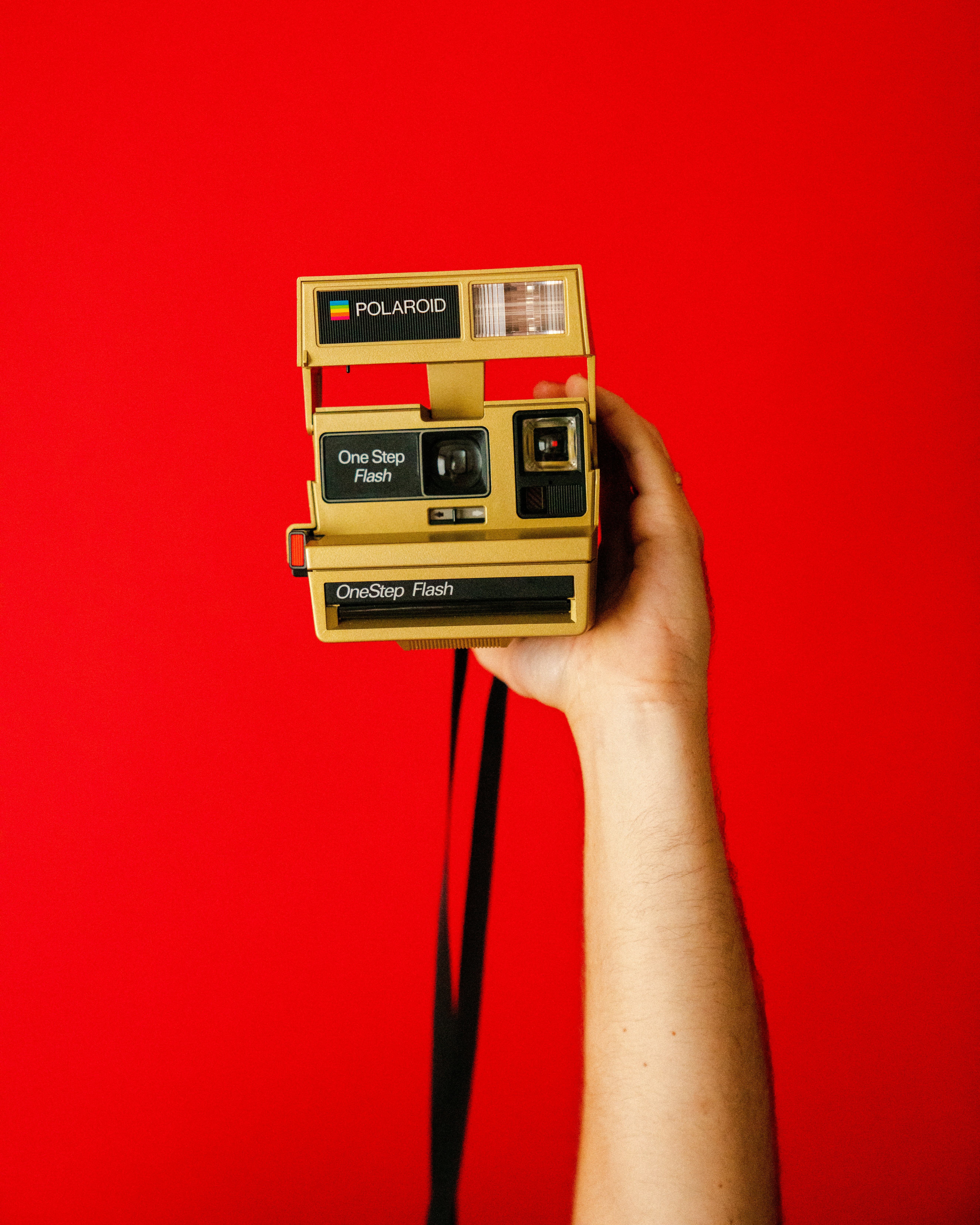 brown and black Polaroid One Step camera