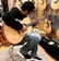 men playing a guitar in a guitar lot room close-up photography