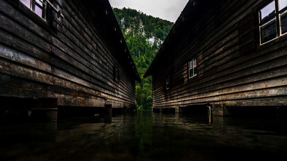two wooden buildings in body of water