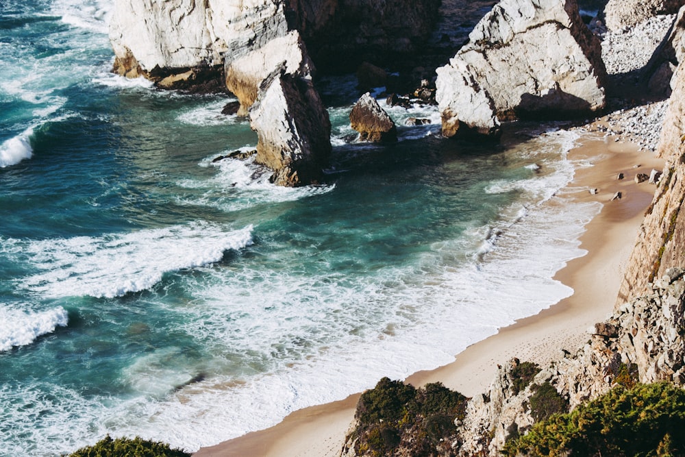 rocks on seashore at daytime