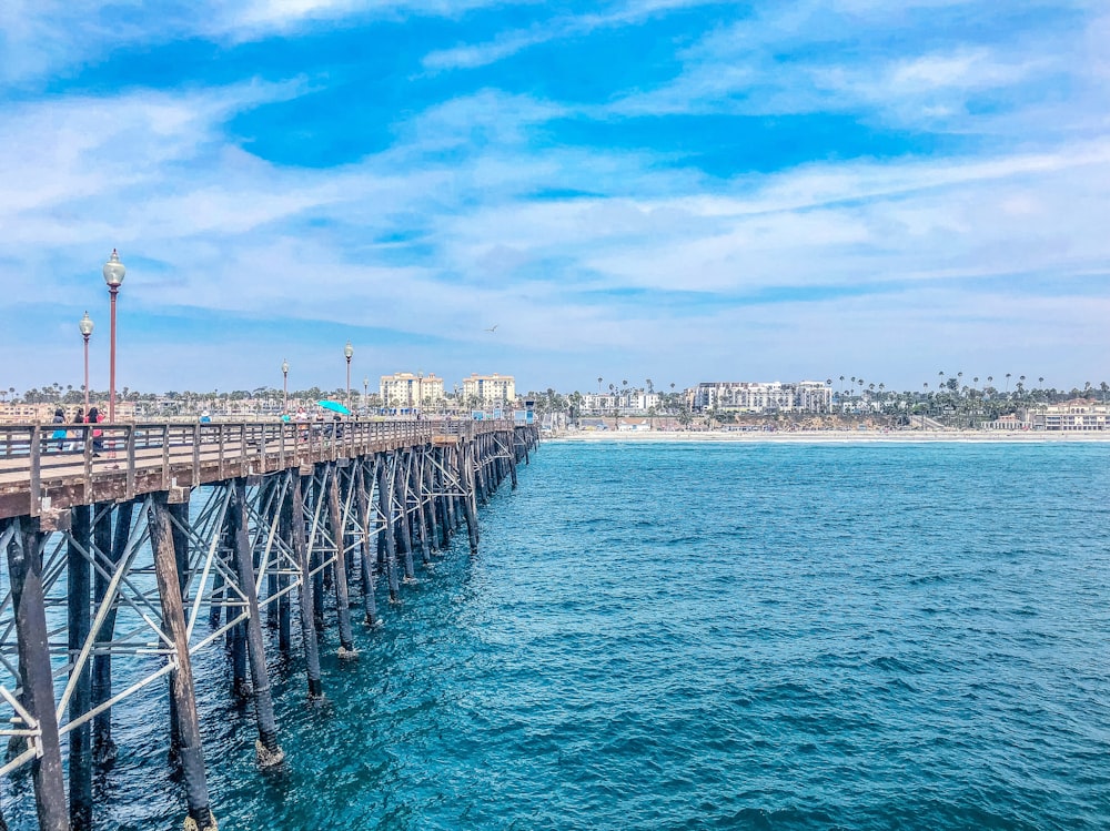 gray and brown bridge towards shoreline