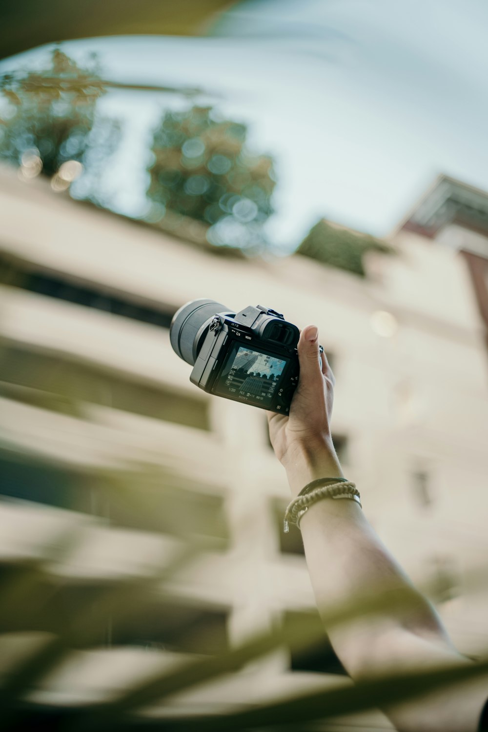 selective focus photography of holding black camera