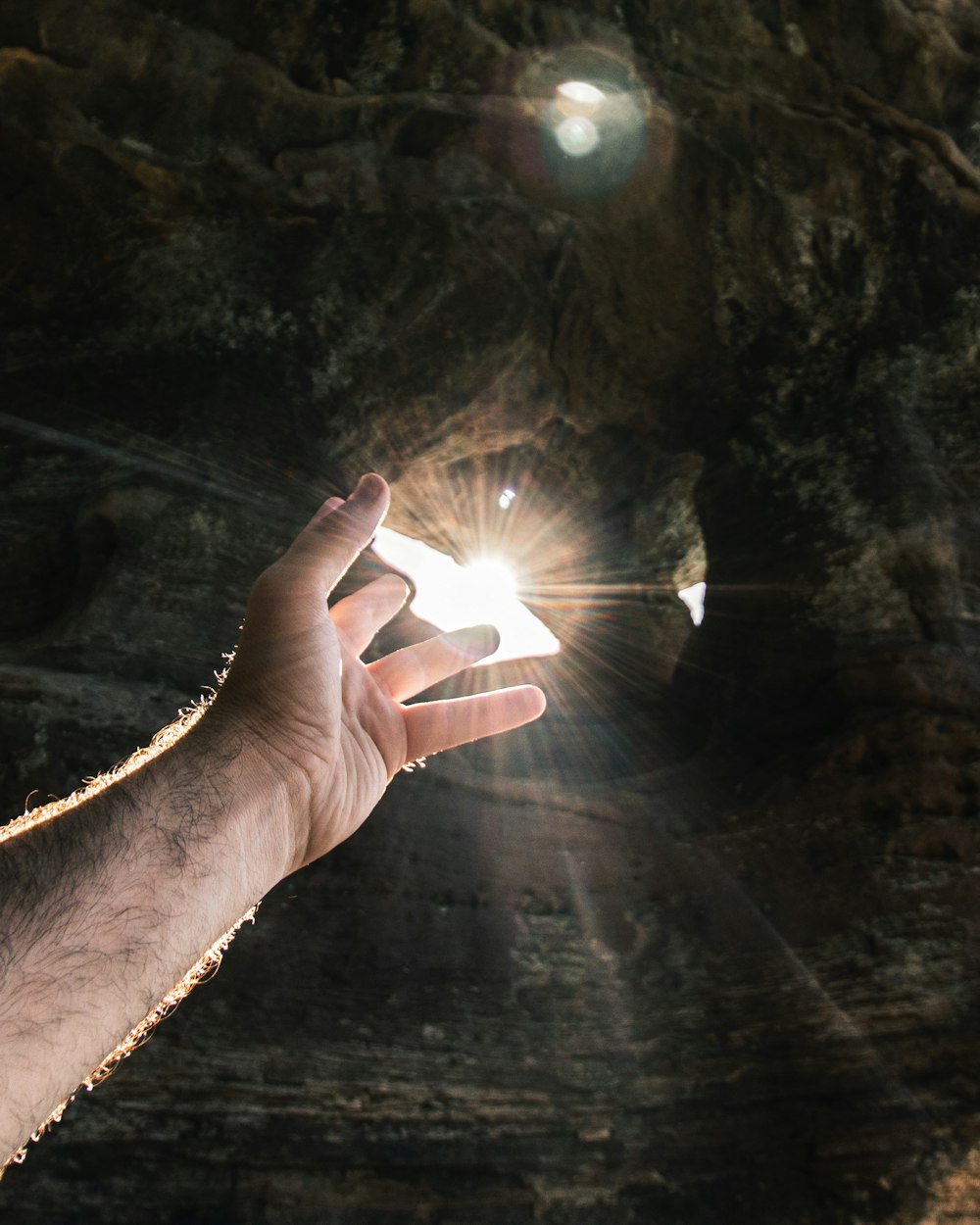 person pointing on sun rays