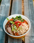 noodles with sliced red bell pepper, carrots, and meat