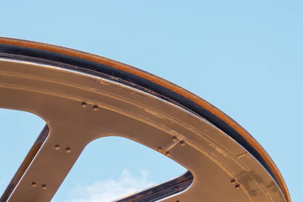 a close up of a metal structure with a sky in the background