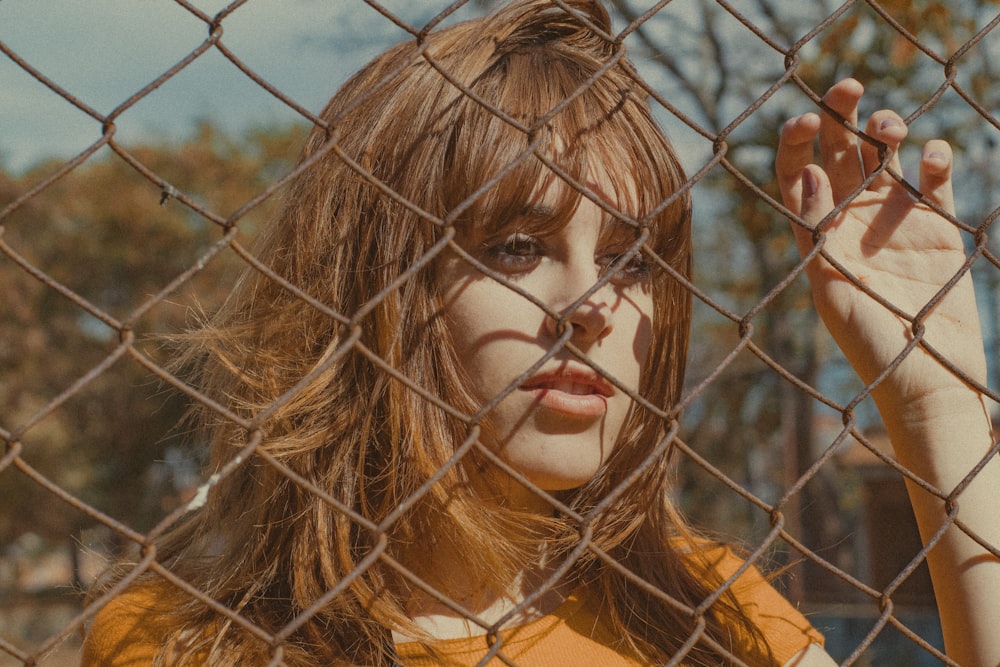 woman leaning on fence