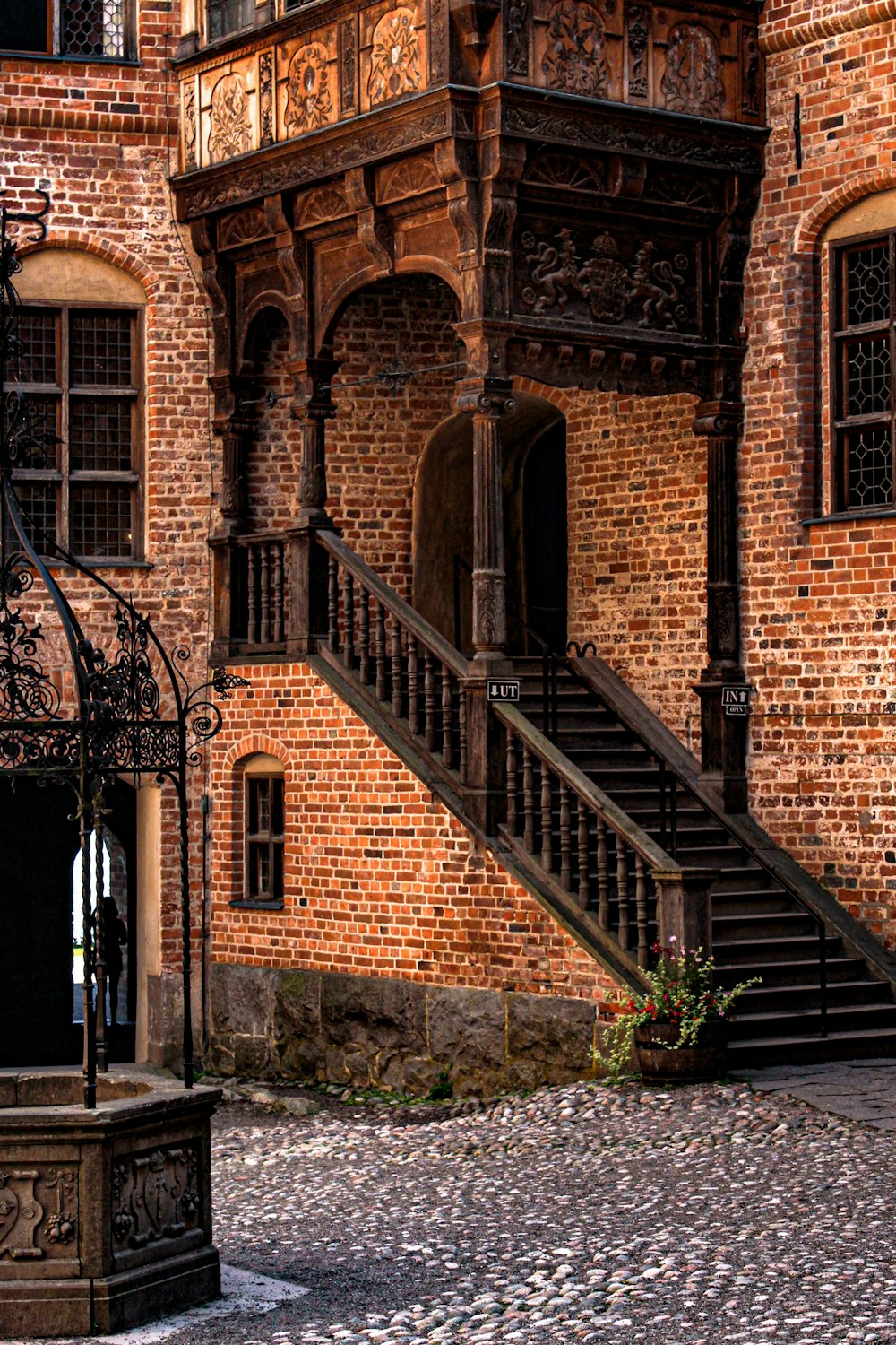 a brick building with a wrought iron staircase