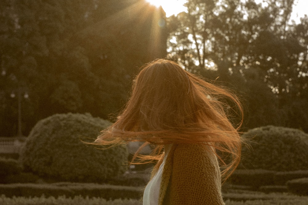 time-lapse photography of woman flipping her hair