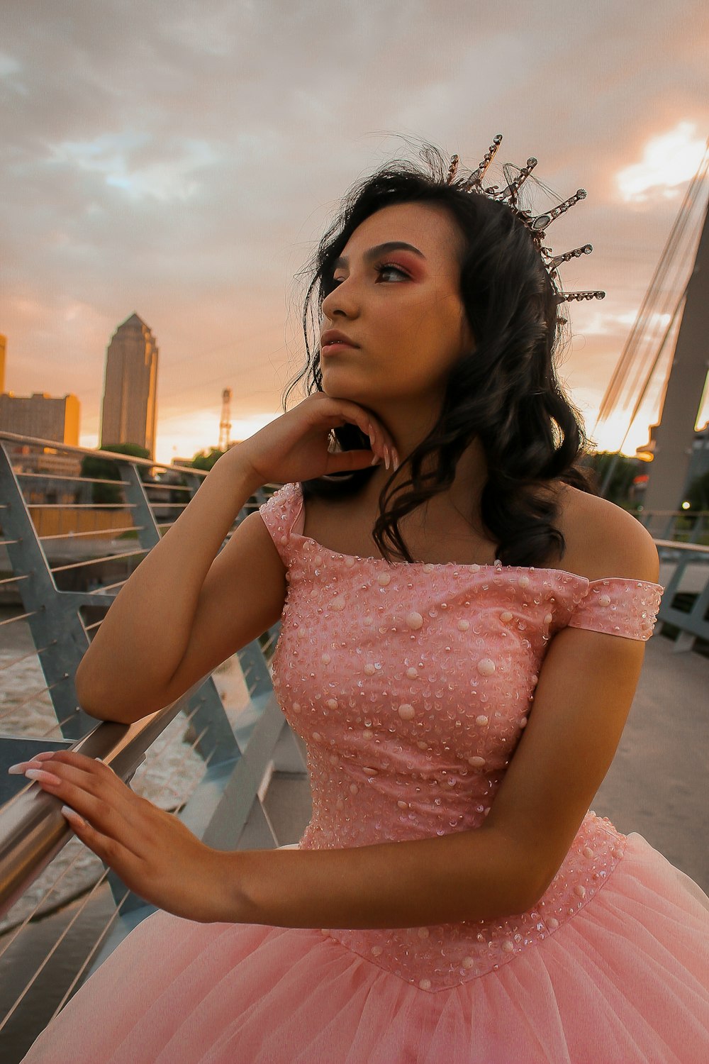 a woman in a pink dress posing for a picture