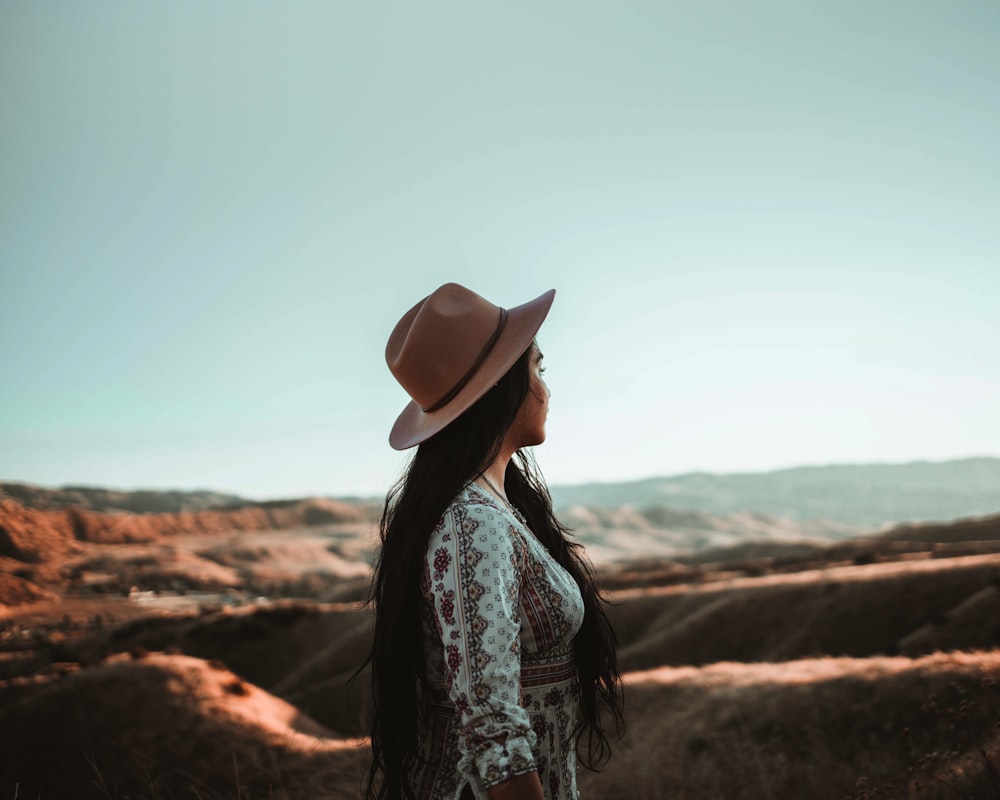 woman standing on top of mountain