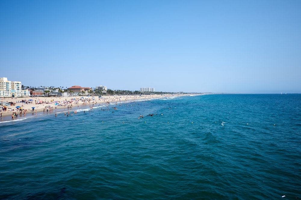 a view of a beach with people swimming in the water