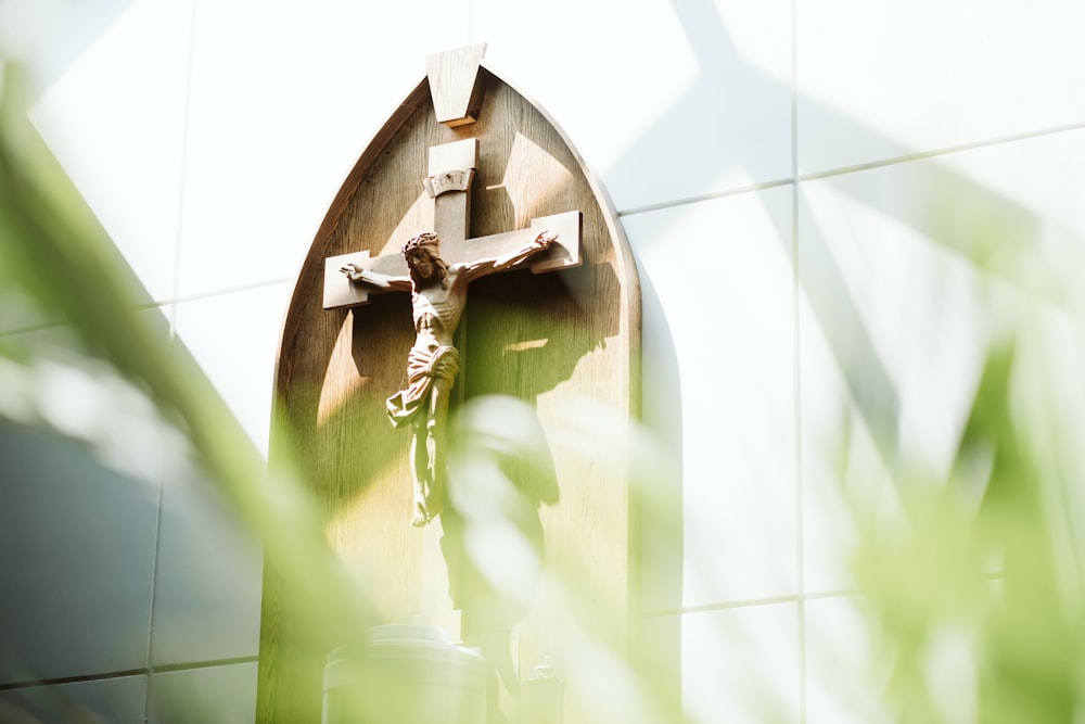 a wooden cross on the side of a building