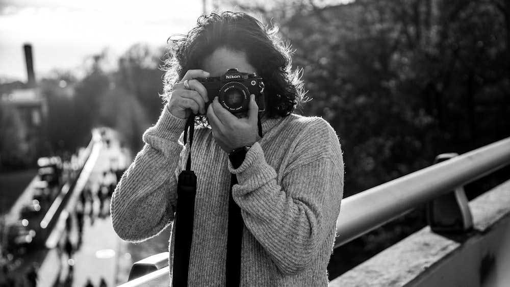 a woman taking a picture with a camera