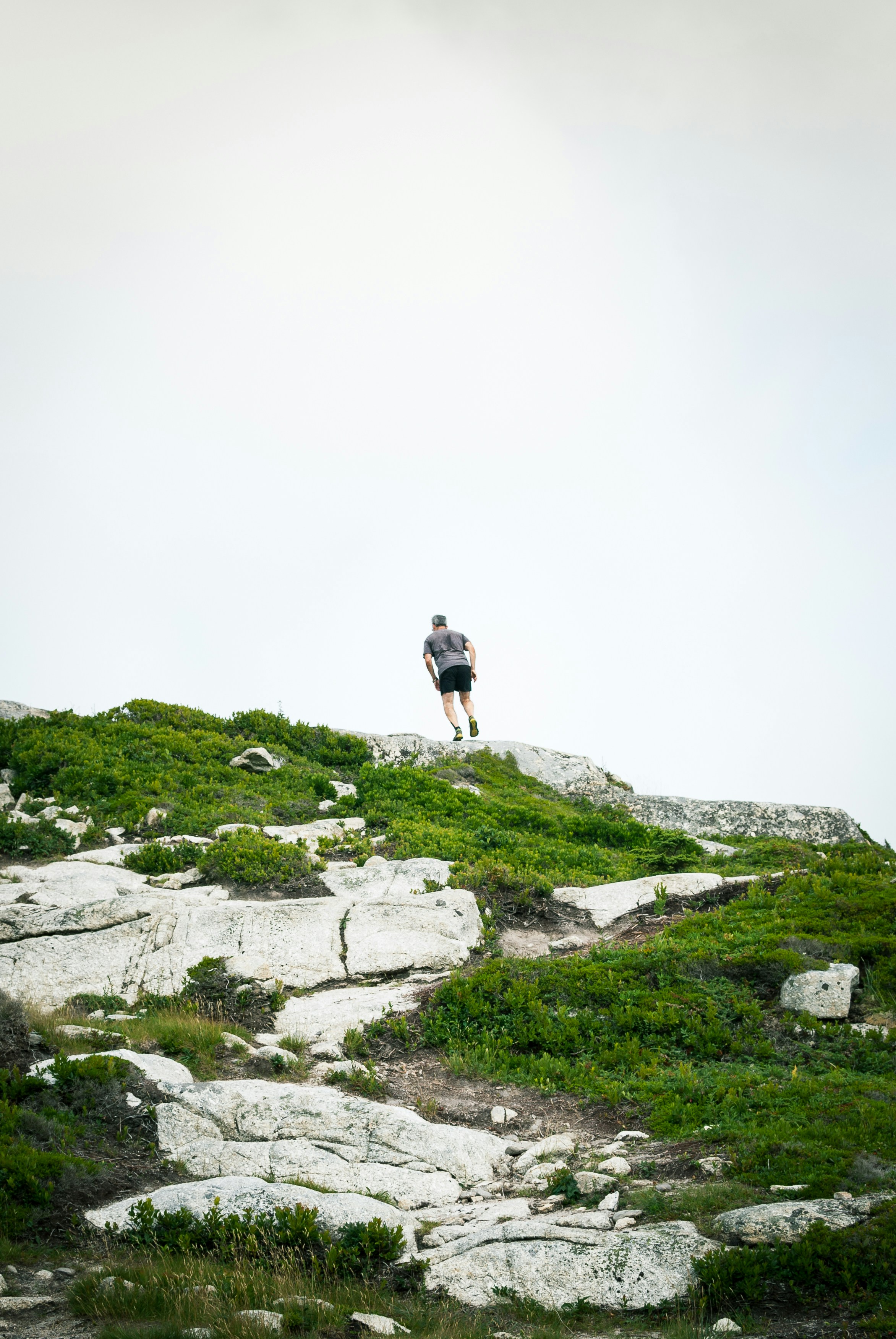man on mountain cliff