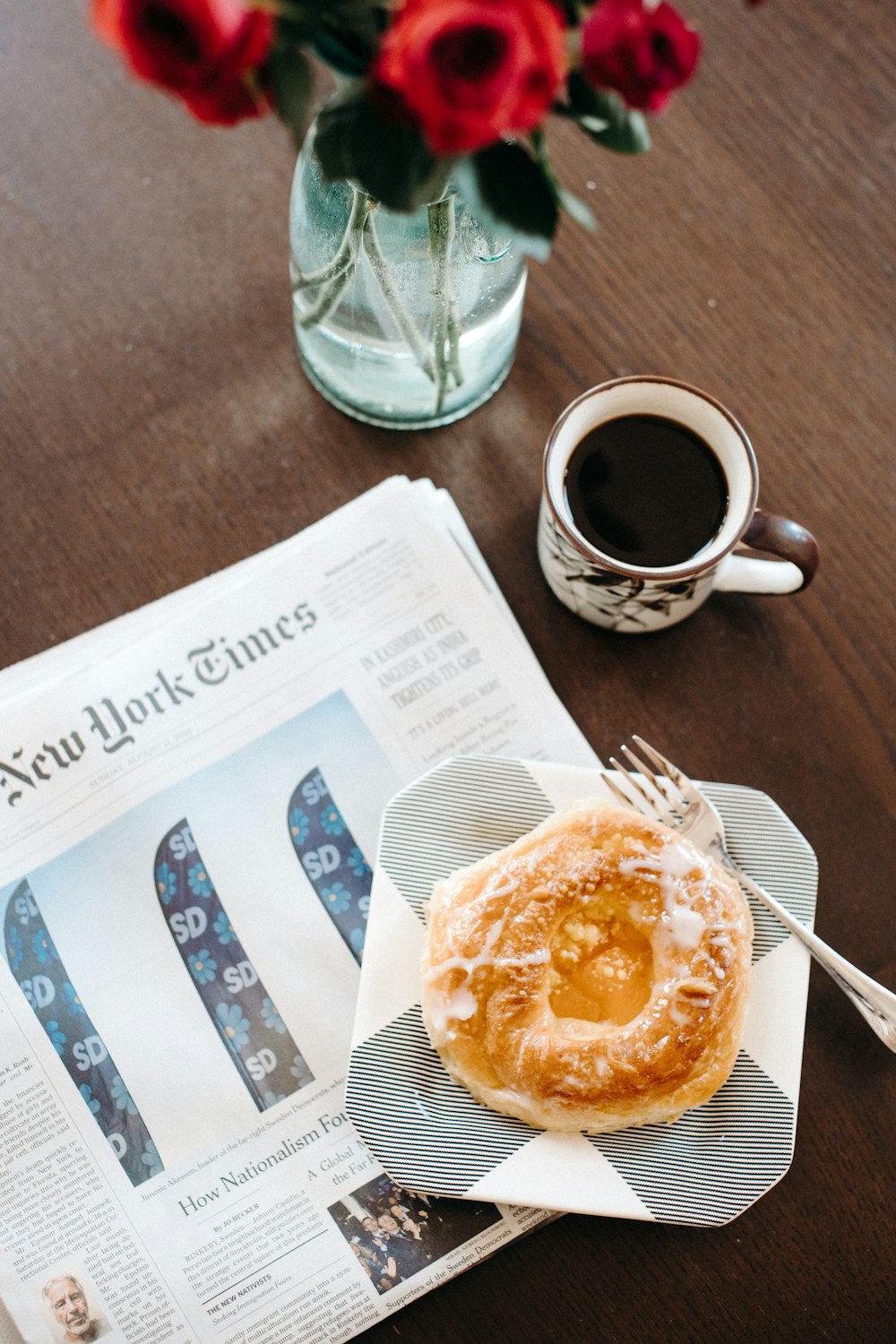 baked bread on plate near mug with coffee