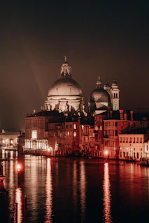 Historic European city skyline viewed from the ship’s deck at twilight, lights beginning to twinkle.