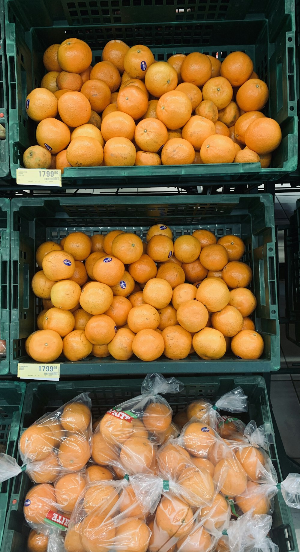 three baskets of oranges