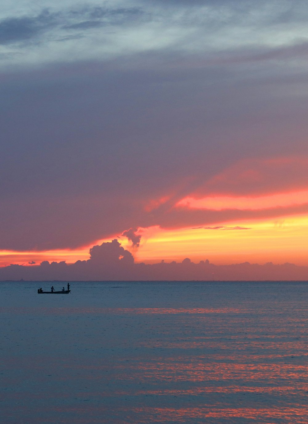 a couple of boats floating on top of a large body of water