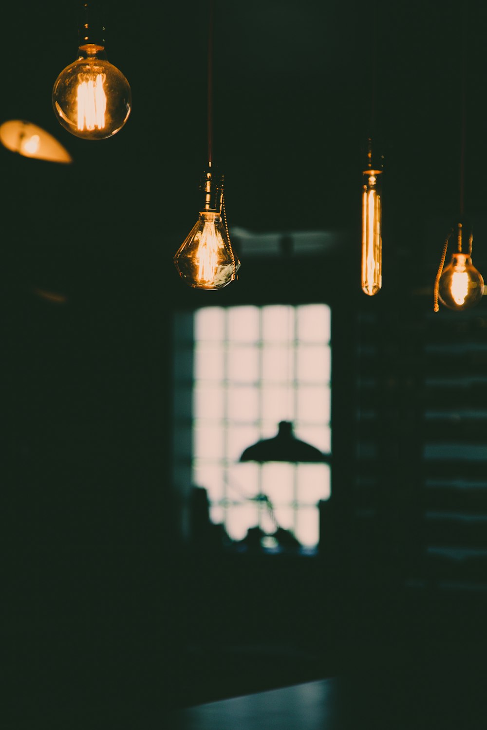 four turned-on yellow Edison light bulbs