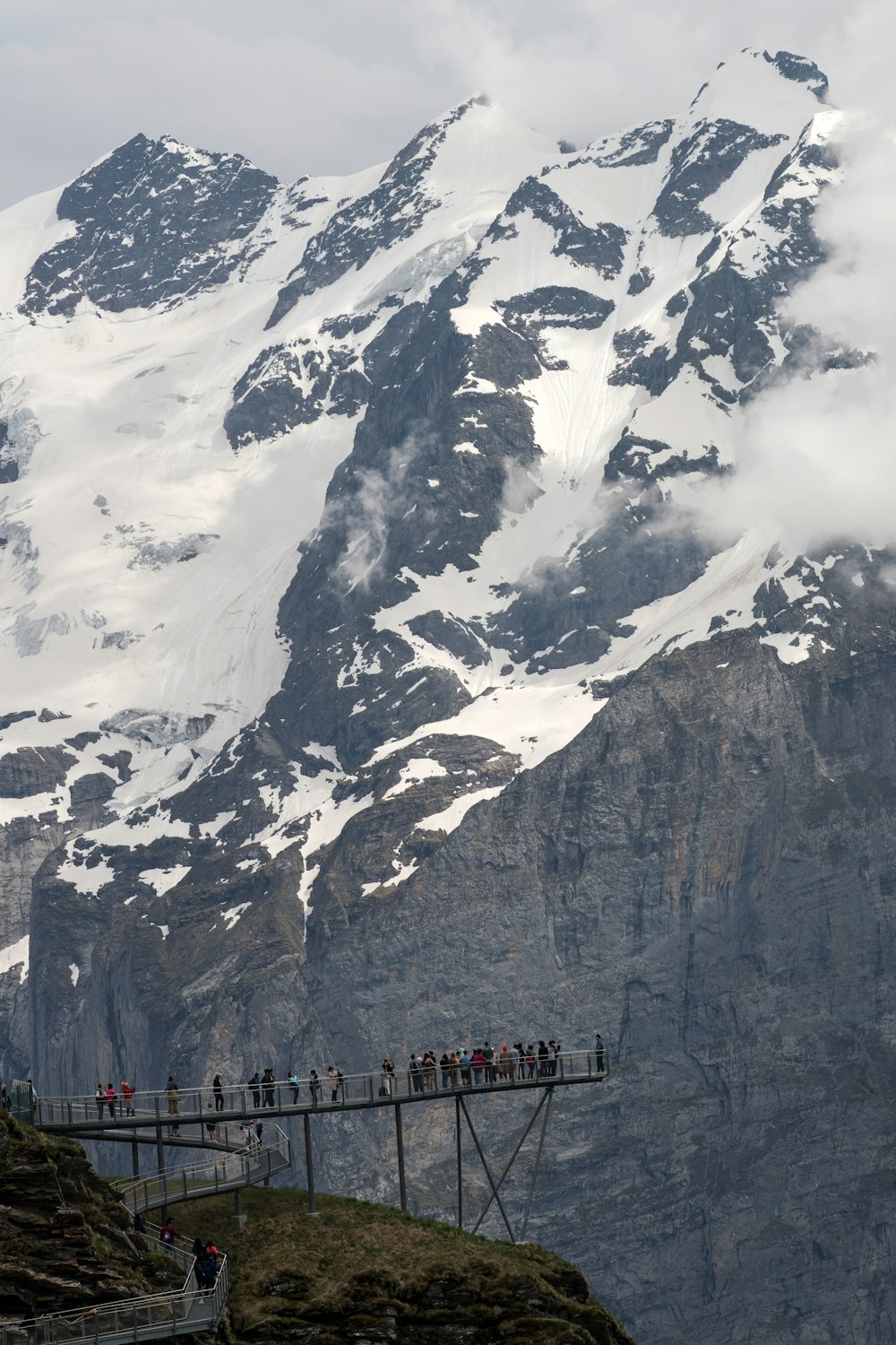 people standing near mountain covered with snow