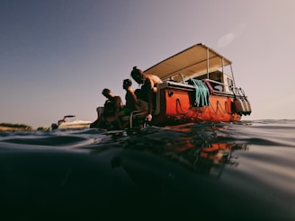 people in boat on sea