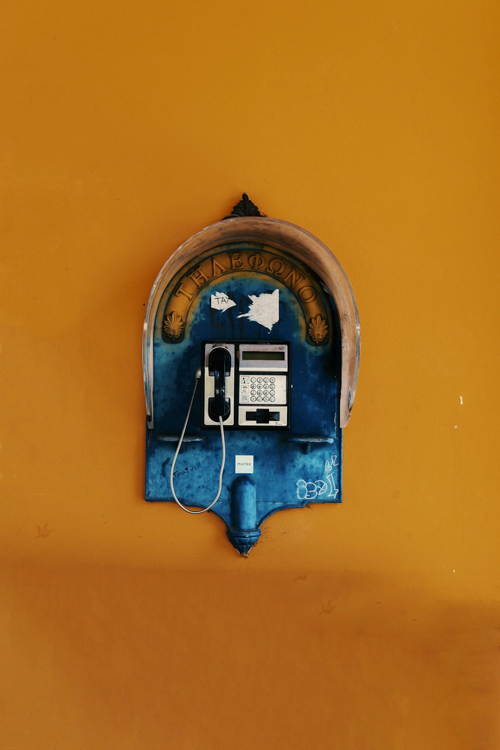 blue and silver telephone on wall
