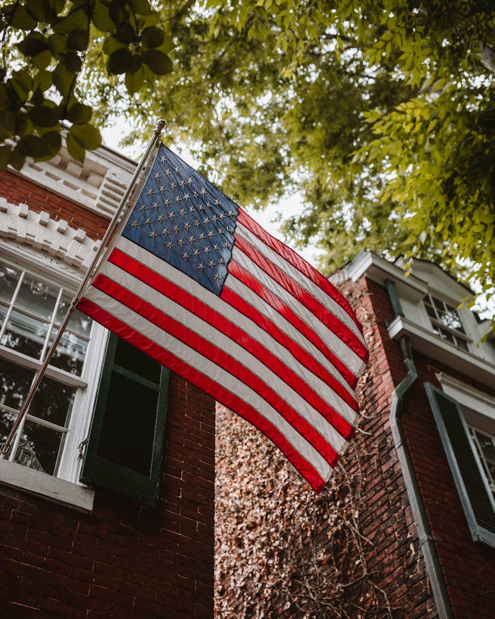 us a flag on brown brick wall