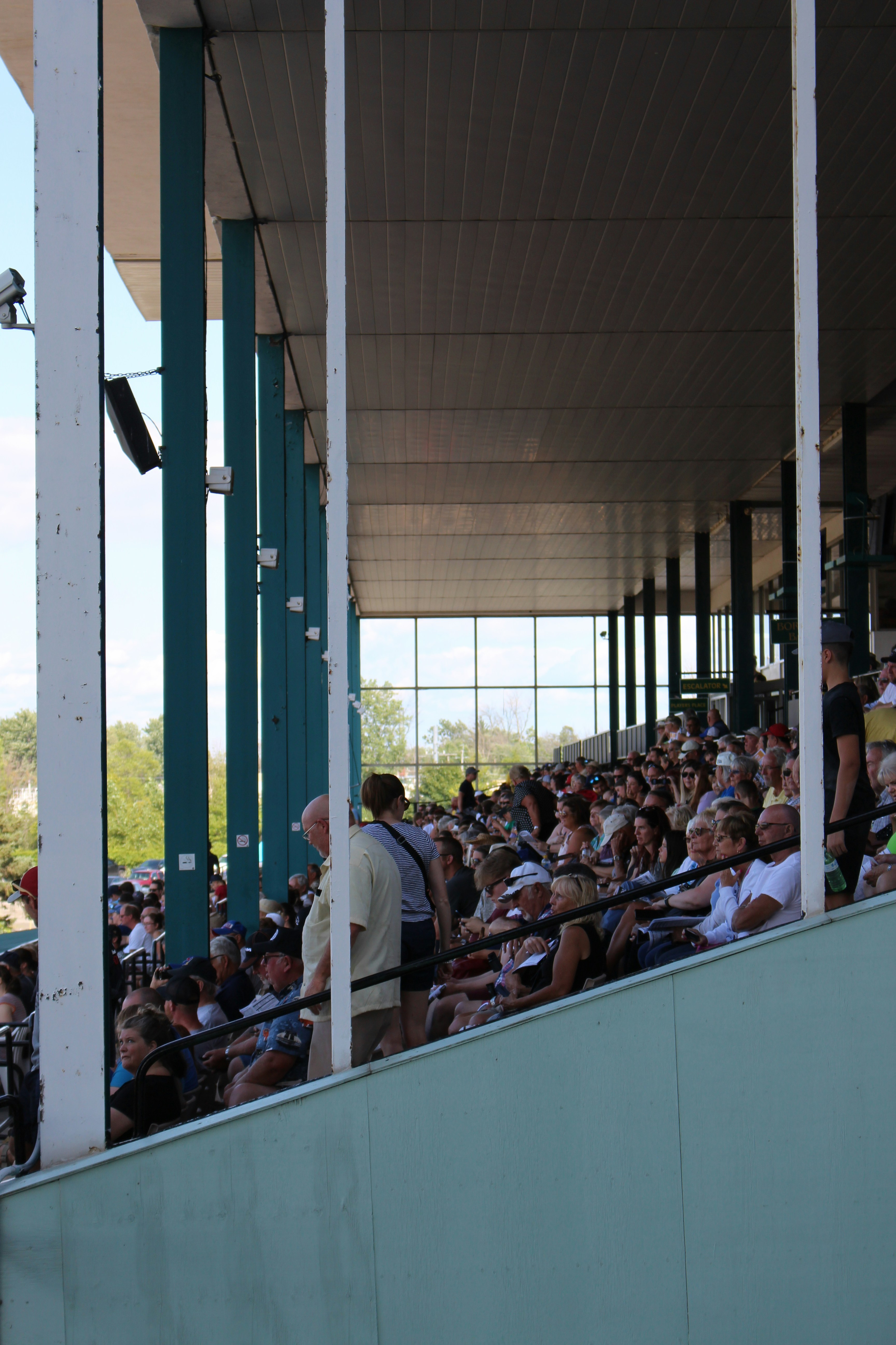 crowd of people sitting on stadium bleachers during daytime