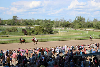 people watching horse race at daytime