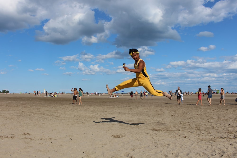 man jumping on seashore