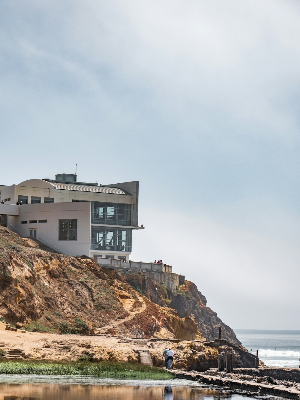 white concrete house near body of water