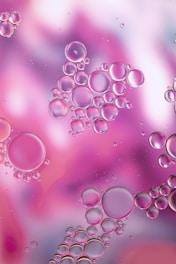 a close up of bubbles on a purple and pink background