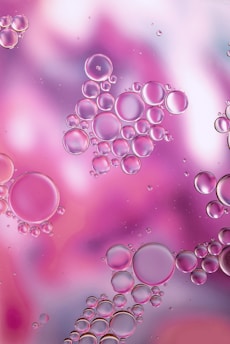 a close up of bubbles on a purple and pink background