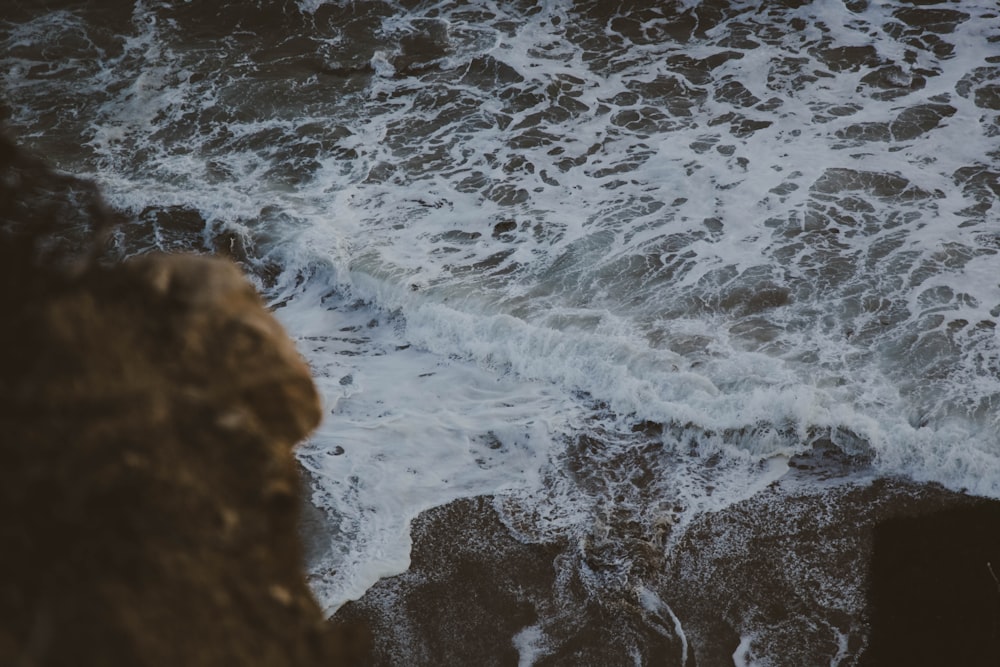 time-lapse photography of waves splashing on rocks