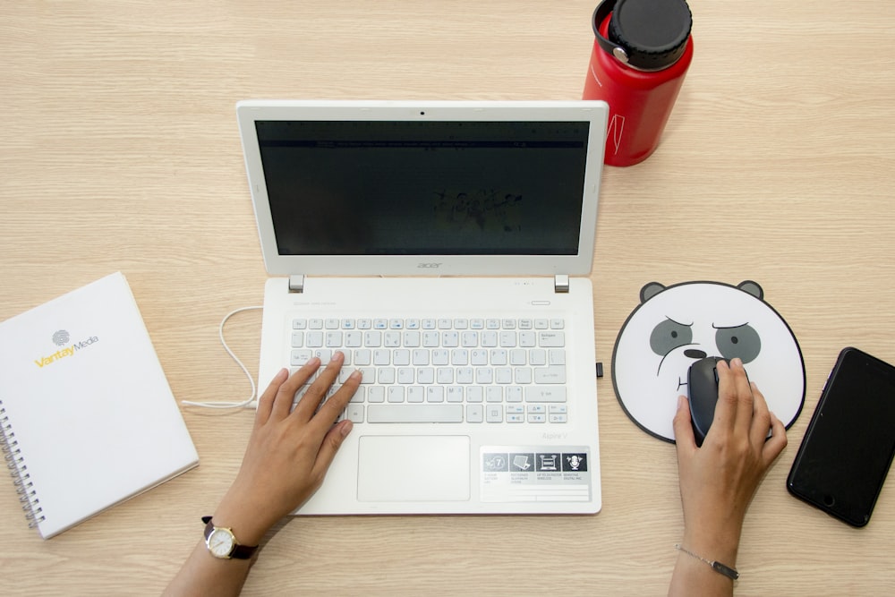 person using white Acer laptop