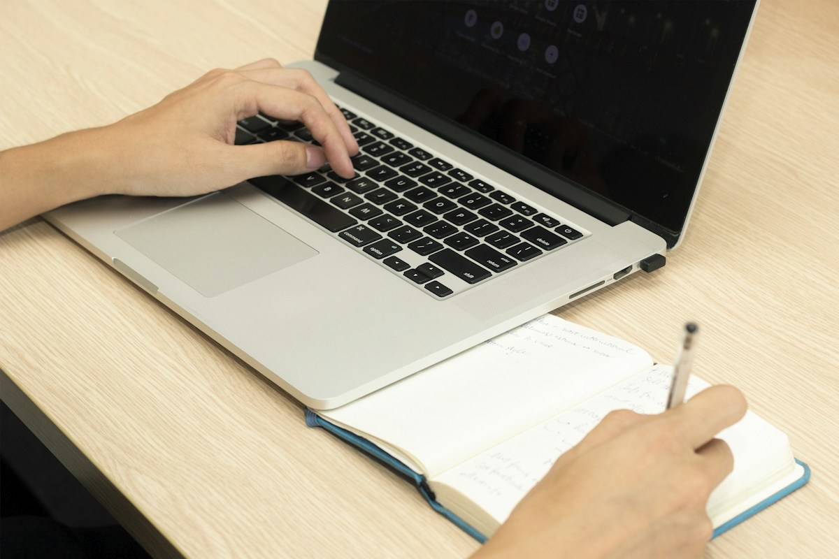 Gray laptop computer on a desk, open to a video call, illustrating online teaching setup and engagement strategies.
