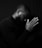 a man with his hands together in prayer