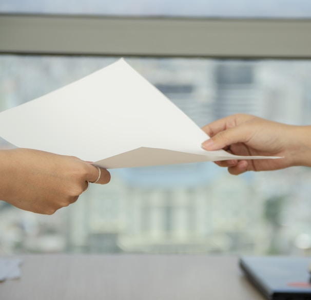 person handing over paper