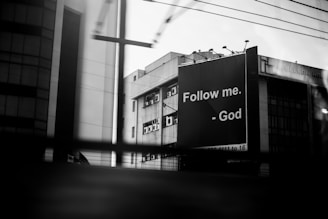 a black and white photo of a building with a cross