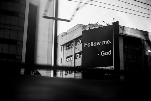 a black and white photo of a building with a cross