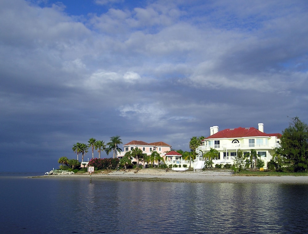 a large white house sitting on top of a beach