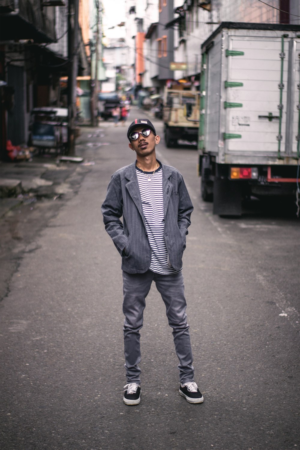 man standing on road